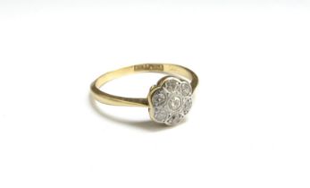 A diamond daisy ring, stamped 18ct/plat. Size M, 1.9g