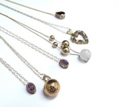 Six 9ct gold chains all hung with pendants including football, heart shaped and amethyst examples,