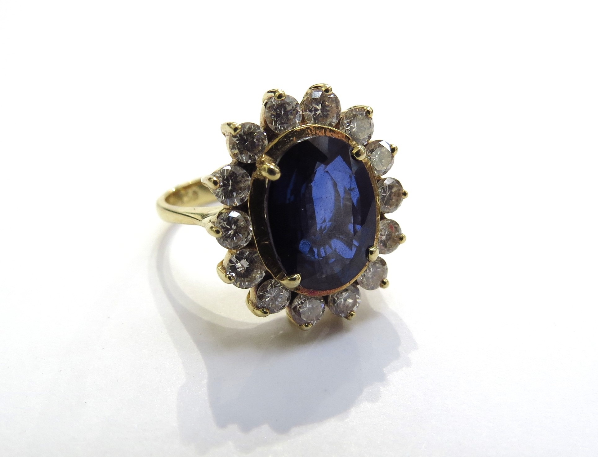 A sapphire and diamond cluster ring the central oval sapphire 11.5mm x 8.5mm, 3.47ct approx set in - Image 2 of 4