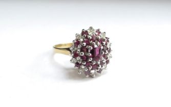 An 18ct gold ruby and diamond cluster ring. Size N/O, 5.4g