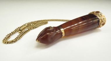A cornelian Figa pendant as a closed fist gold mounts stamped 18k 6.5cm long, hung on a gold chain