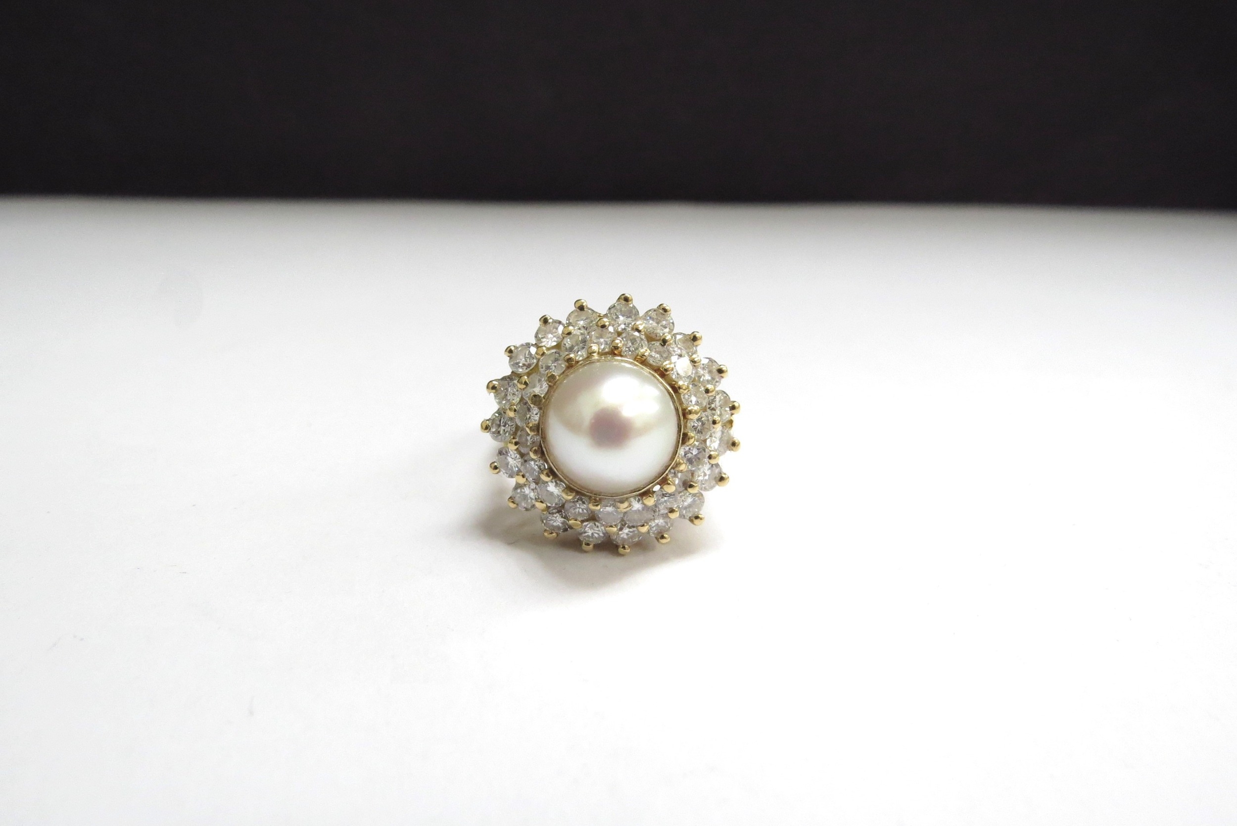 An 18ct gold pearl and diamond ring, the centre pearl 9mm framed by two rows of brilliant cut - Image 2 of 3
