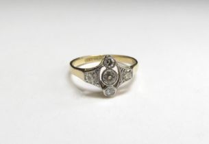 An Art Deco diamond ring, three diamonds in vertical setting flanked by diamonds in open mount,