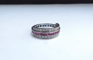 A half sapphire half ruby ring with two rows of hinged diamonds that can be worn wine side,