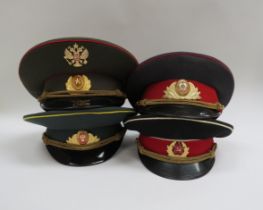 Four Russian peaked visor caps: Two USSR Soviet era officer's and two Russian Federation (one with