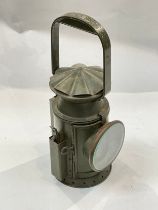 A British military railway hand-held signalling lamp dated 1956 with lenses and burner with wick