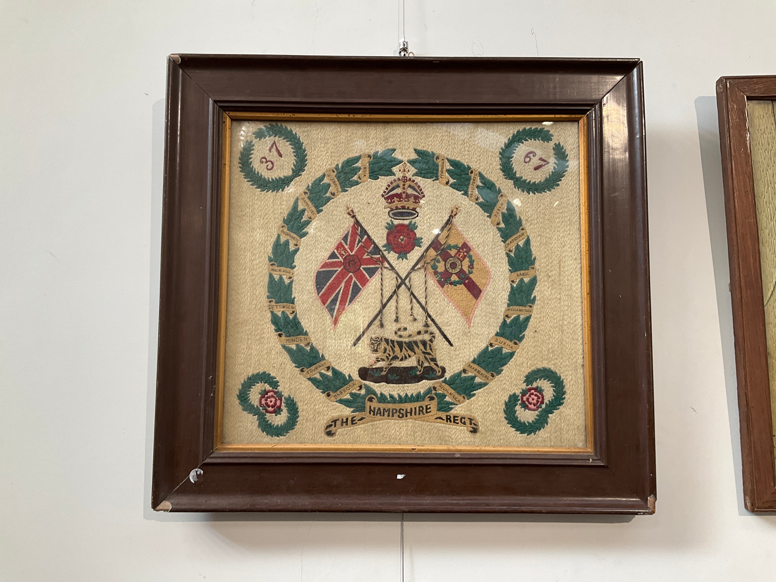 A WWI Hampshire Regiment tapestry together with a Boer War 10th Hussars tapestry, both framed and