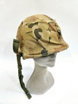 A US Vietnam War era helmet with liner and camouflage cover