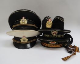 A quantity of USSR Russian Soviet peaked headwear including two Naval officer’s caps, two sailor’s