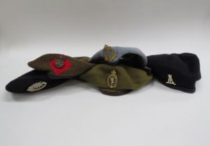 Five various berets with badges including Pioneer Labour Corps, George Crown Military Police,