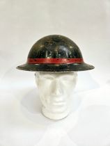 A WWII British Home Front steel helmet, black with stencilled indistinct lettering in white PFR /