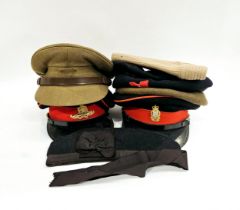 A box of military hats including officer's peaked dress hats, berets and side hats