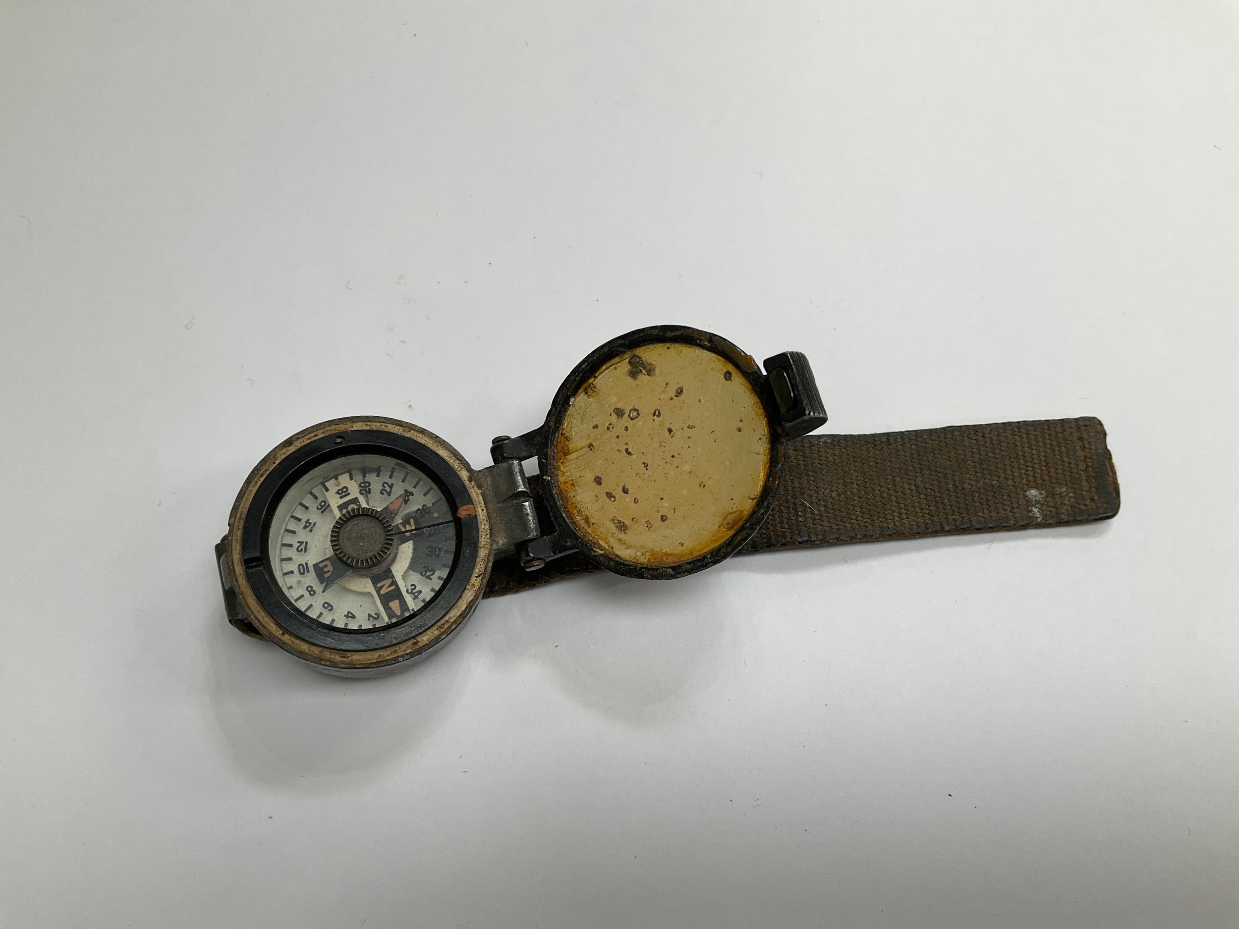 A WWII British wrist compass, stamped to rear 6B/2593, strap a/f