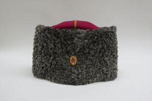 A USSR Russian Soviet Papakha astrakhan fur hat with pink top, gold trim, bearing gilt and red