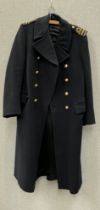 A WWII Royal Naval Great Coat dated 1940 to label, together with a battledress jacket (mothed) dated