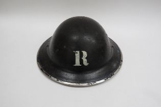 A WWII British Home Front Rescue Party Steel Helmet, black with stencilled white “R” to the centre