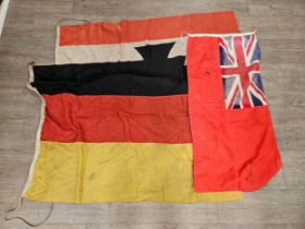 Three flags: German with central cross upon a white background, red border, German with three tone