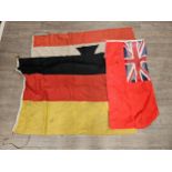 Three flags: German with central cross upon a white background, red border, German with three tone