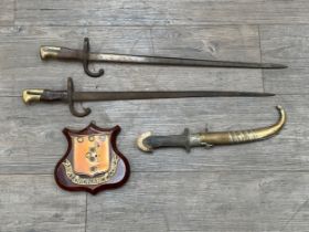 Two 19th Century French Gras bayonets, together with an Arabic dagger and Ordnance Corps plaque (4)
