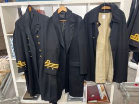 Two Royal Navy great coats including Bakelite buttoned, together with a cloak (3)