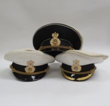 Three Russian Federation Naval officer's peaked visor caps, two white with black band, the other