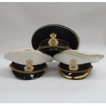 Three Russian Federation Naval officer's peaked visor caps, two white with black band, the other