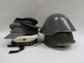 An East German helmet, a French M78 F1 helmet, together with three others (5)