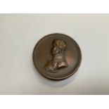 A 19th Century commemorative bronze coin-form box, the obverse cover with side profile of the Duke