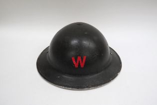 A WWII British Brodie helmet, the shell re-painted in black to outside with applied 'W' (Warden)