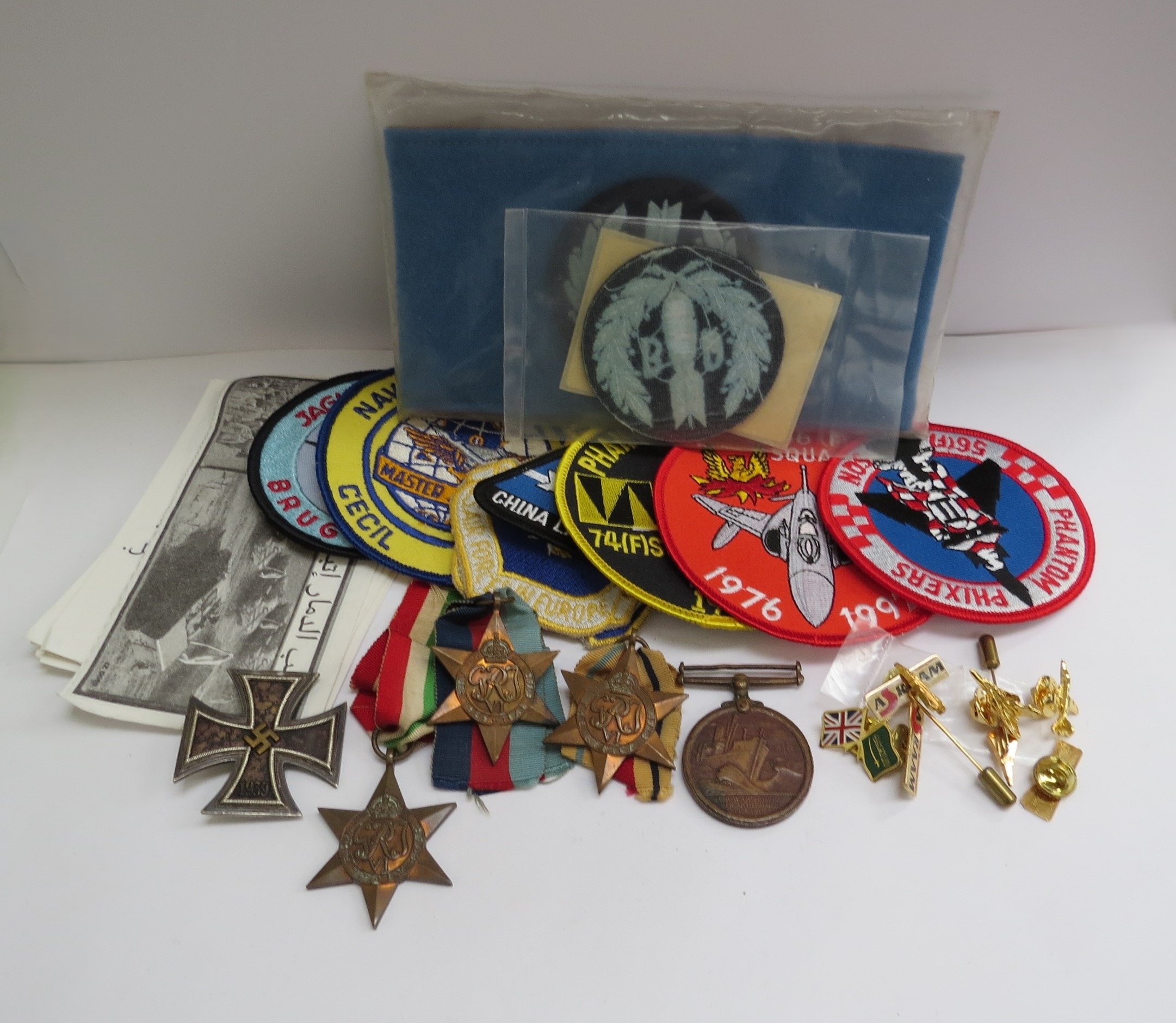 A quantity of militaria including WWII star medals, German Iron Cross 1st class (paint removed),