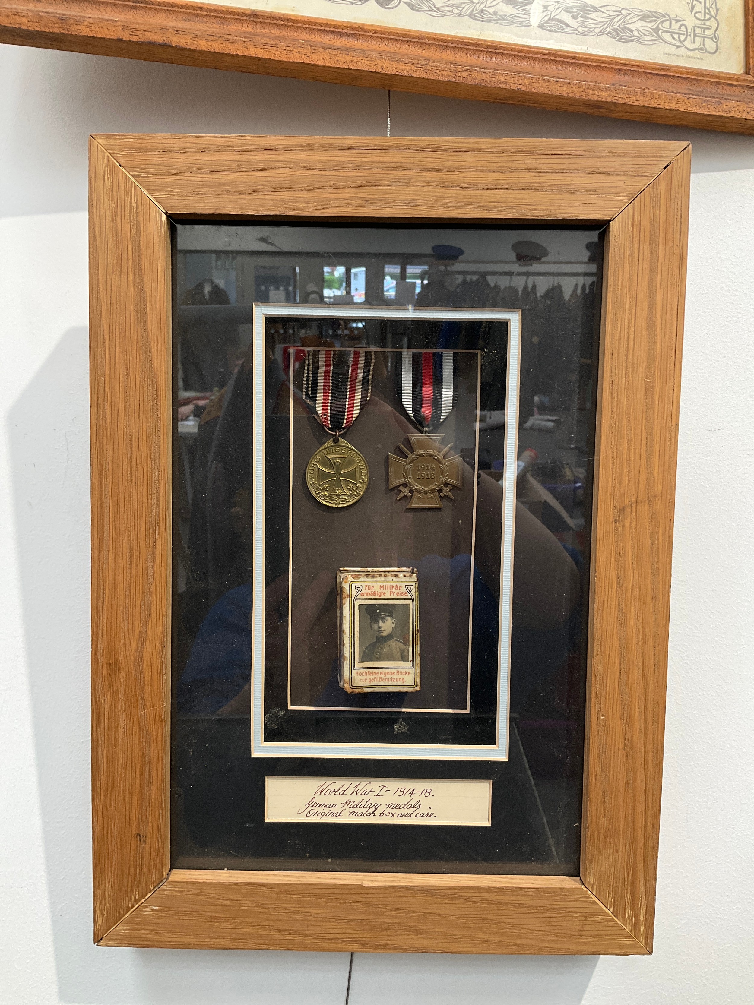 A framed pair of German WWI medals with matchbox