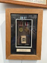 A framed pair of German WWI medals with matchbox