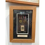 A framed pair of German WWI medals with matchbox