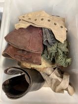 A box of miscellaneous militaria including 1944 dated mosquito spats, leather boots, buskins,