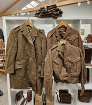 A quantity of 1950's British Army uniform including battledress, trousers, greatcoat and putties,