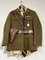 A post-war British Army Service Dress uniform with Norfolk Regiment insignia, together with an