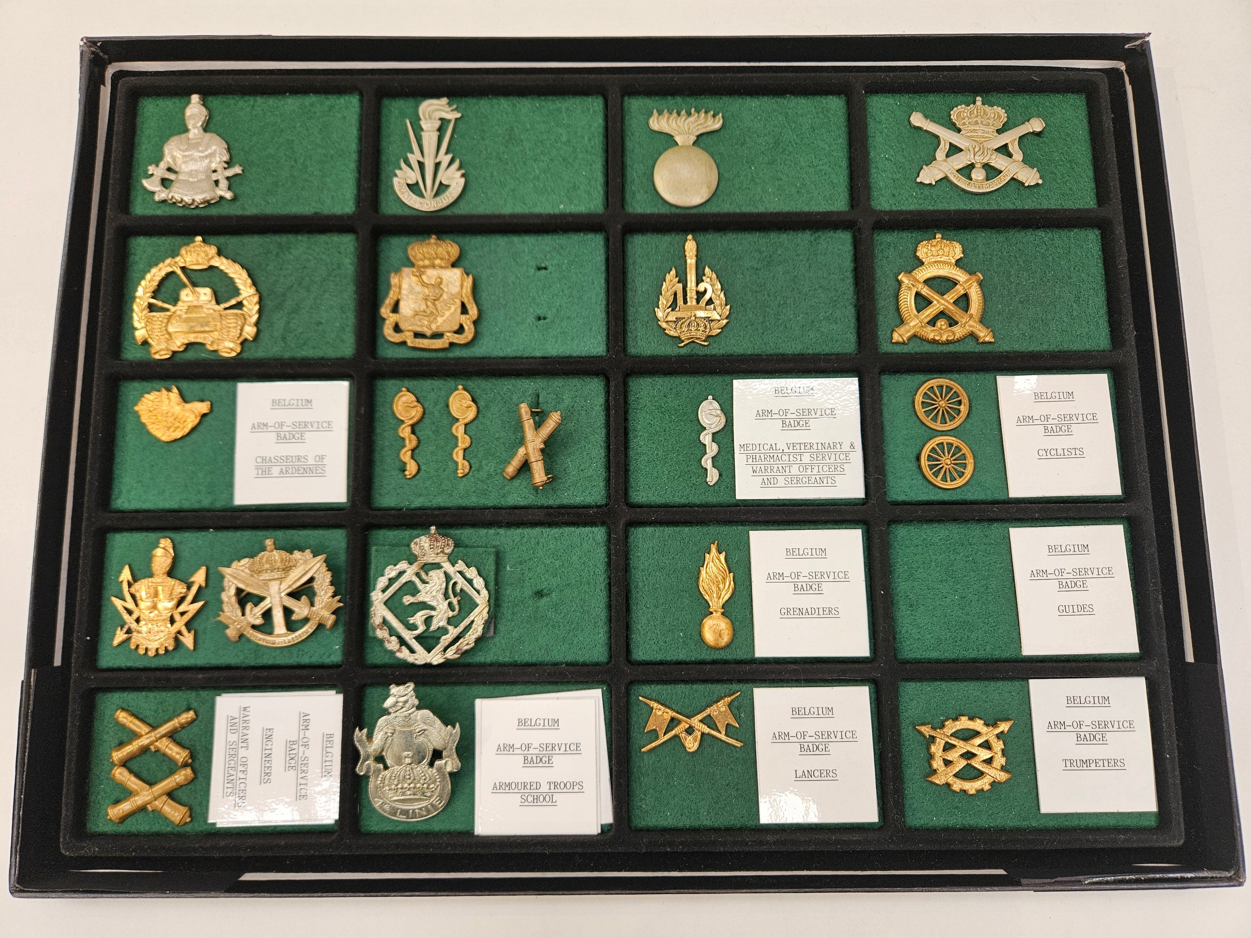 A case of mixed military badges, mainly Belgian