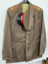 A USSR Russian Soviet Army officer's uniform consisting of peaked visor cap, red band with star,