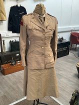 A WWII US women's army uniform consisting of jacket, skirt, hat, blouse and belt with insignia