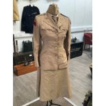 A WWII US women's army uniform consisting of jacket, skirt, hat, blouse and belt with insignia