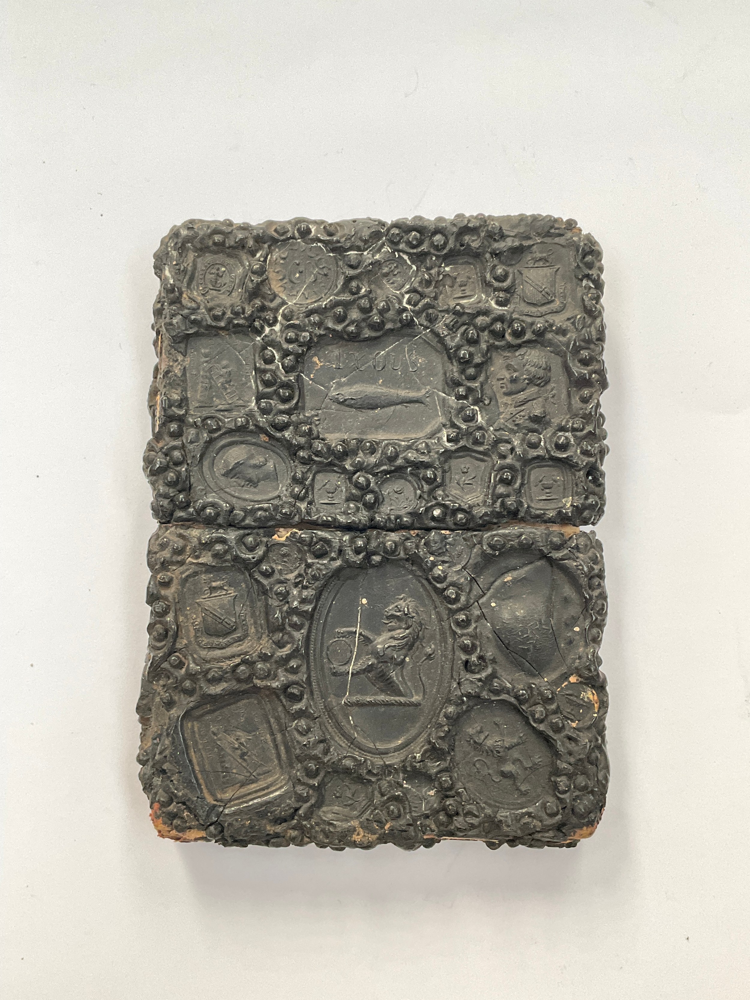 A 19th Century Gutta Percha card case of rectangular form, impressed with various seals including