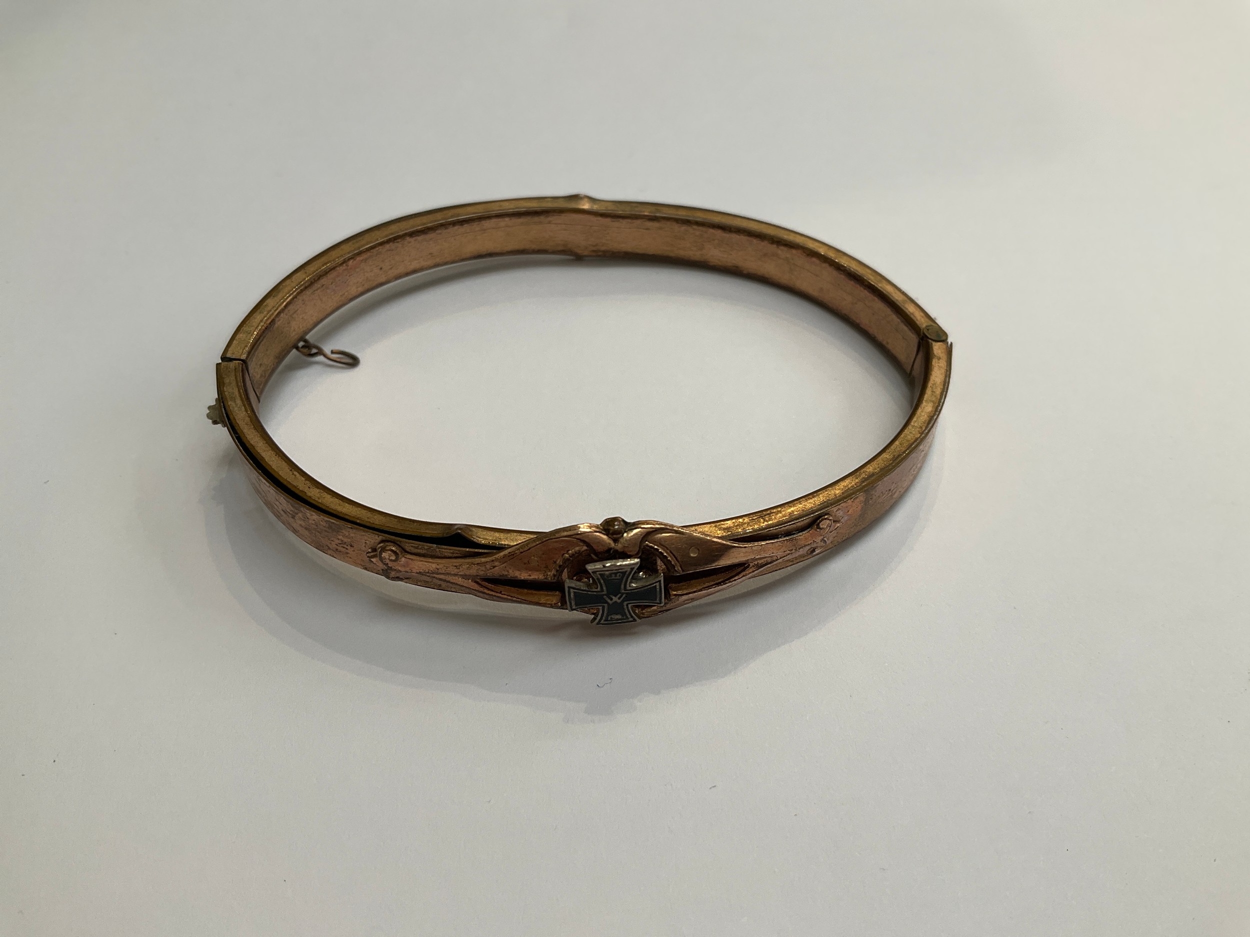 A German sweetheart bracelet with applied WWI Iron Cross detail, within a brown leather pouch