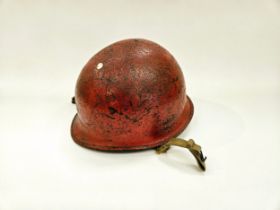 A post-war US helmet with liner, re-painted in red