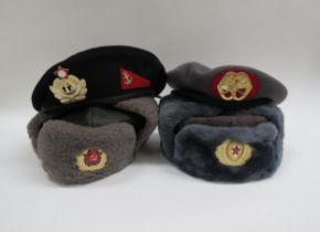 Two Russian Soviet USSR ushanka winter service hats together with two berets (4)