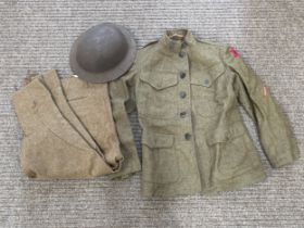 A WWI US Brodie helmet together with WWI US soldier's service jacket and breeches