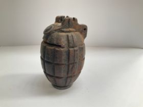 A WWII Mills No. 36 hand grenade converted into a money box, slit cut through the top
