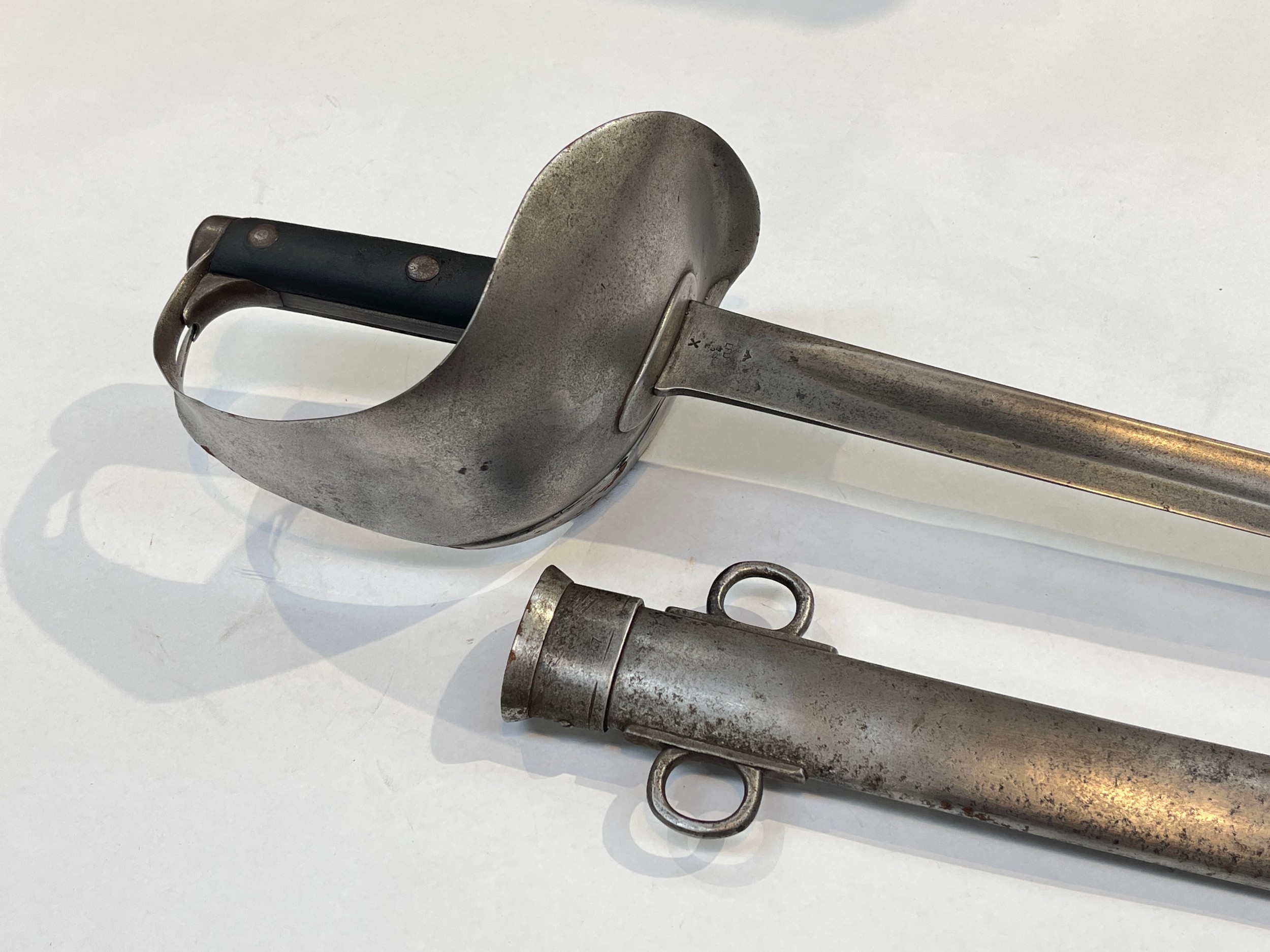 An 1899 pattern cavalry troopers' sword, the sheet steel bowl hilt with leather riveted grip joining