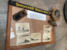 A framed display of original photographs of the Graf Spee, together with a Kriegsmarine ship’s wheel