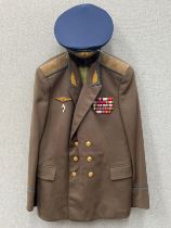 A Russian USSR Soviet Air Force officer’s jacket together with a praised visor cap, blue piping