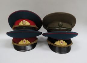 Four USSR Russian Soviet peaked visor caps including Army Officer (dark green with red band and